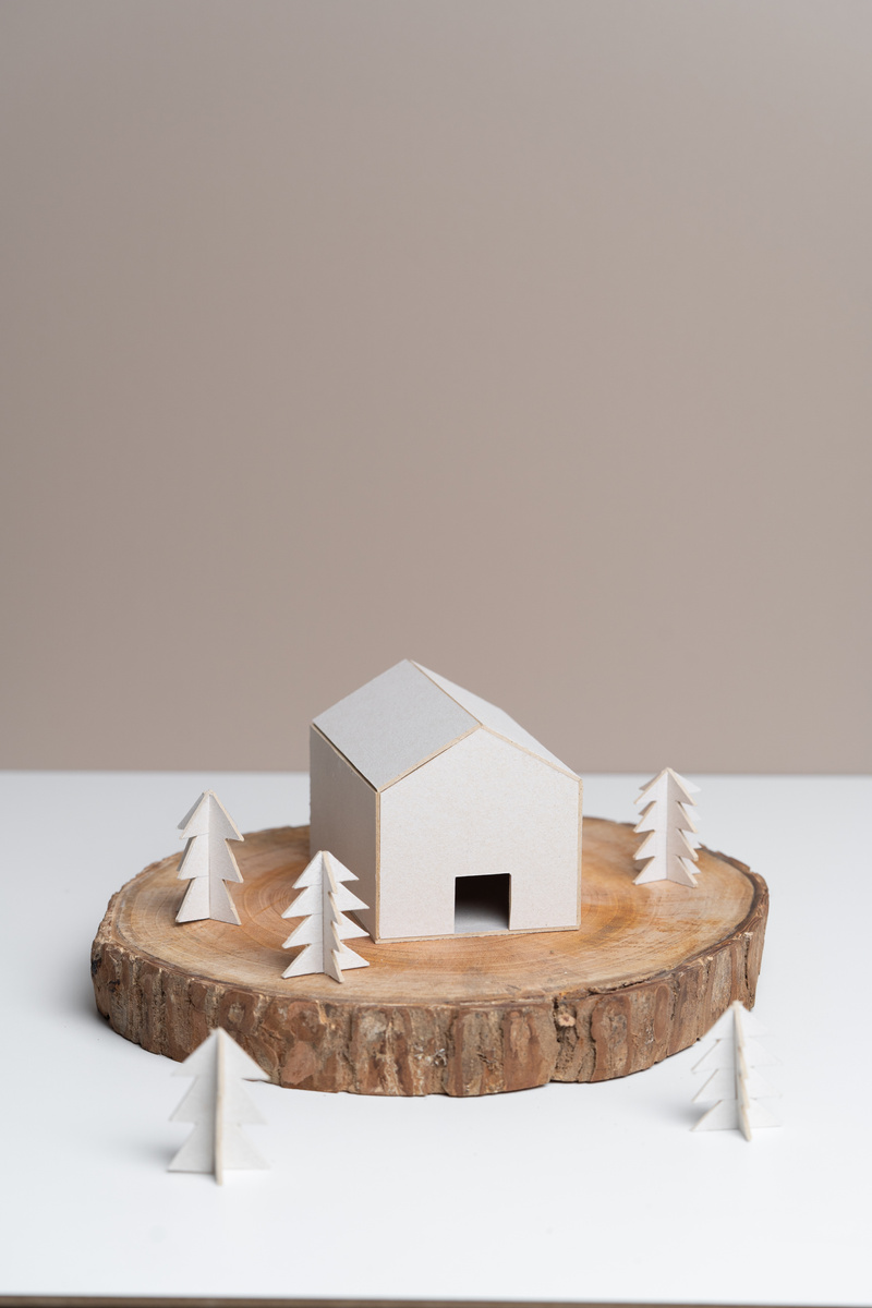 Paper House and Trees on Wooden Podium